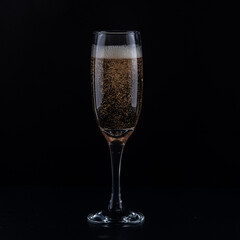glass of champagne on black surface 