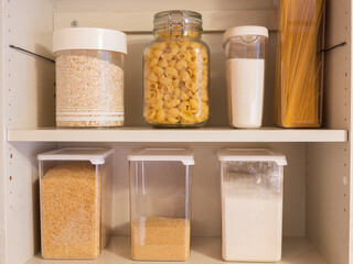 Various dry goods on a shelf. Jars of pasta and other carbon hydrate rich foods. Prepping inspiration.