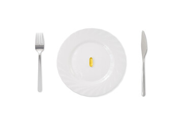 Fish oil capsule on white plate with fork and knife
