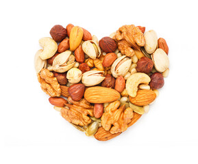 Heart shaped nuts and seeds isolated on white background close-up, flat lay, top view
