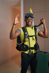 Smiling man in scuba suit showing ring gesture