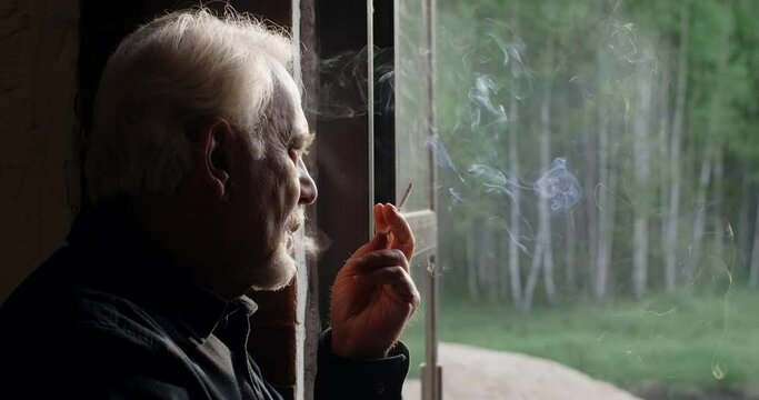 Sad old gray haired man smokes cigarette, sorrow and sadness of the old man, 4k 60p Prores