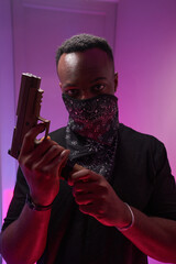 Male inserting clip into handgun before camera