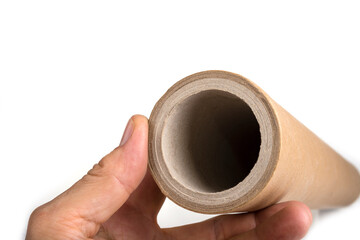 Empty paper tube from a material on a white