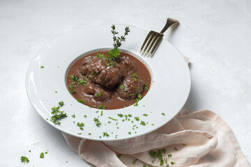 Traditional stew of homemade beef and lamb meatballs in tomato sauce