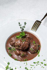 Traditional stew of homemade beef and lamb meatballs in tomato sauce