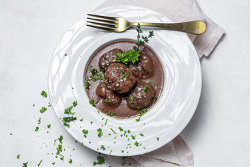 Traditional stew of homemade beef and lamb meatballs in tomato sauce