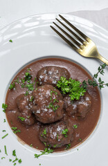 Traditional stew of homemade beef and lamb meatballs in tomato sauce