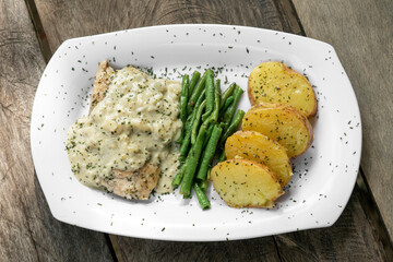 chicken breast with blue cheese sauce and roast potatoes