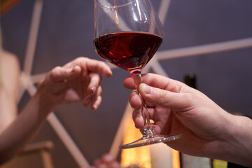Glass of wine passed from one person to another