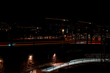 Fototapeta premium Long exposure at night with train and cars