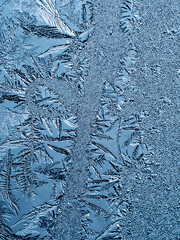 Ice crystals in the detail on a window glass in winter time