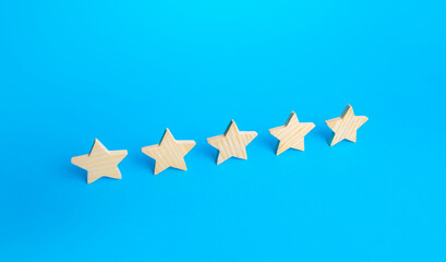 Five stars are in a row on a blue background. Rating evaluation concept. Popularity of restaurants, hotels or mobile applications. Service quality feedback. Great reputation. High satisfaction.