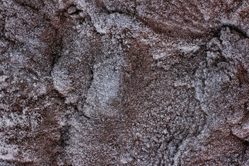 textured background of frost-covered relief stone