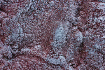 textured background of frost-covered relief stone