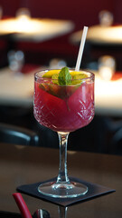 Alcoholic cocktails in a dark-lid bar environment from Berlin, Germany.