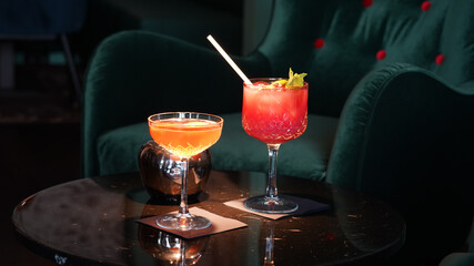 Alcoholic cocktails in a dark-lid bar environment from Berlin, Germany.