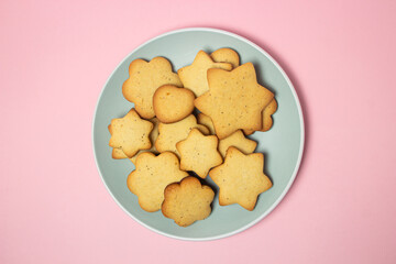 Homemade shortbread cookies on a pink background. Delicious and light dessert. Cookies on a plate.
