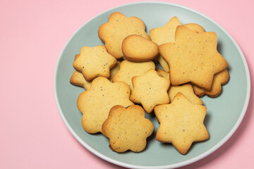 Homemade shortbread cookies on a pink background. Delicious and light dessert. Cookies on a plate.