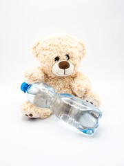 Teddy bear with water in plastic bottle - children soft toy on white background