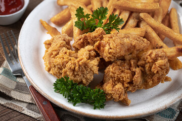 Crispy fried chicken tenders and french fries