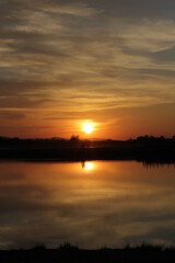 Naklejka premium sunset over the river