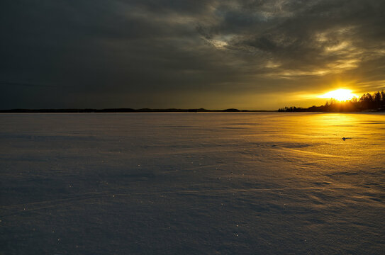 sunset in the frozen snowy winter lake Vanaja Finland
