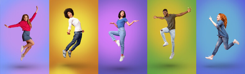 Full length of millennial international people jumping together, smiling at camera over bright neon studio backgrounds - Powered by Adobe