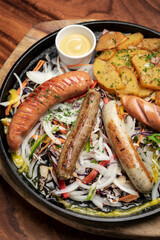 mixed german traditional organic sausage and potato meal platter