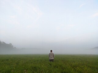 man and person walking in the field