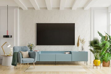 Fototapeta TV on the cabinet in modern living room with armchair on plaster wall background. obraz