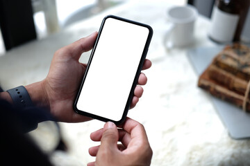 Businessman hand holding smart phone with empty screen.