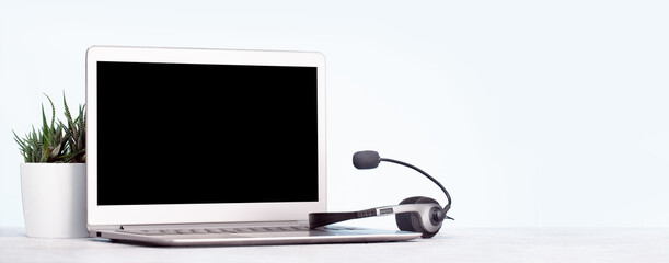 business and communications. Front view of mockup laptop monitor with headset. Conference call,...