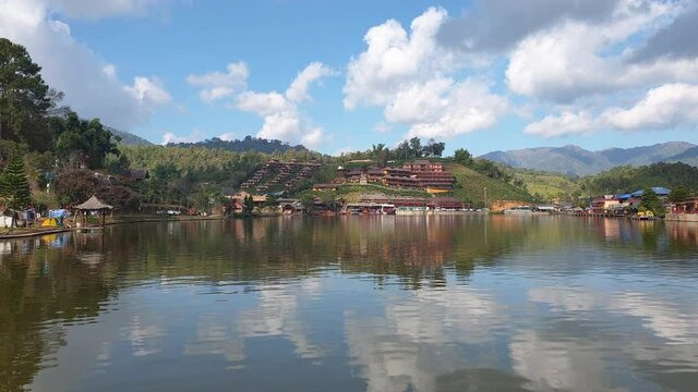 Pan view of Mae Hong Son, Thailand. Lake and resorts in Ruk Thai local chinese thai village in mountain highland slow motion