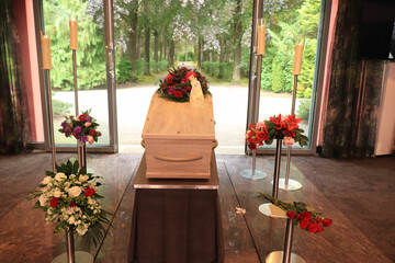 A coffin with a flower arrangement in a morgue - 479355707
