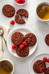 Oatmeal cookies with raspberries and herb tea cups,on bright background. Top view. Breakfast table.