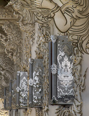 Fototapeta na wymiar Chiang Rai, Thailand - Sep 05, 2020 : Elaborate sculptures of windows at the famous Wat Rong Khun (White Temple) in Chiang Rai, Thailand. Selective Focus.