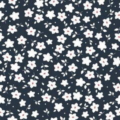 Beautiful vintage pattern. White flowers and leaves . Dark blue background. Floral seamless background. An elegant template for fashionable prints.