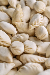 Fototapeta premium Raw dumplings as background, top view. Home cooking, close-up.