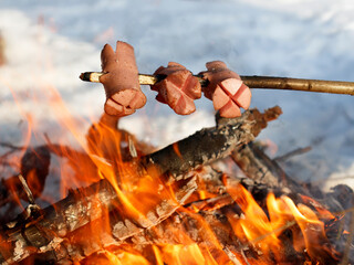 Traditional Czech barbecue - sausages on a stick roasted on the campfire. Sausages on the stick...