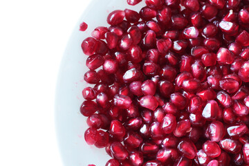 red healthy pomegranate on white dish