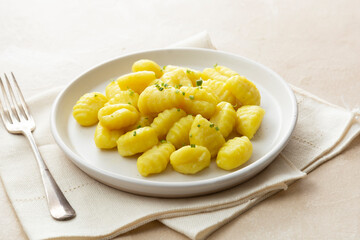 Potato dumplings gnocchi mediterranian food. Cooked gnocchi with butter and green onions.