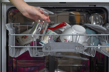 Get clean washed dishes from the dishwasher
