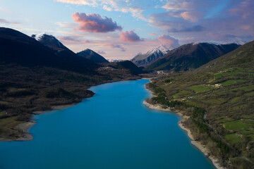 aerial view of the lake of barrea with the snow-capped mountains of abruzzo