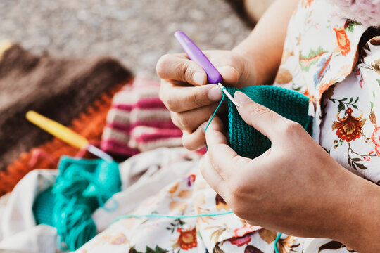 Close-up of hands knitting crochet in the street