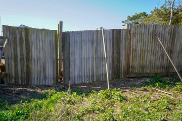 Old broken wooden fence in a garden