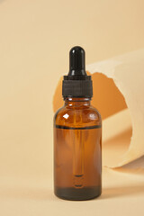 Dropper Bottle with clipping path on a beige background