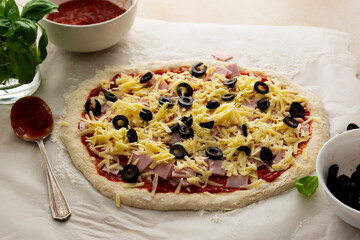 Pizza coooking process with sourdough homemade natural wild east dough. Uncooked pizza