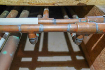 Underfloor copper pipework in a house  