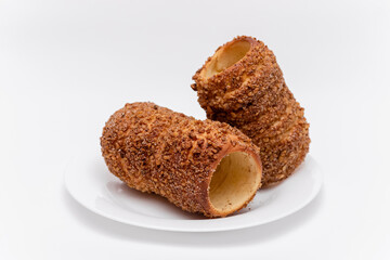 trdelnik on a on a white plate on a white background